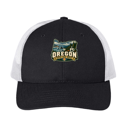 Black and white Oregon trucker cap with mountain, forest, coffee mug, and “Coffee, Rain, Repeat” graphic